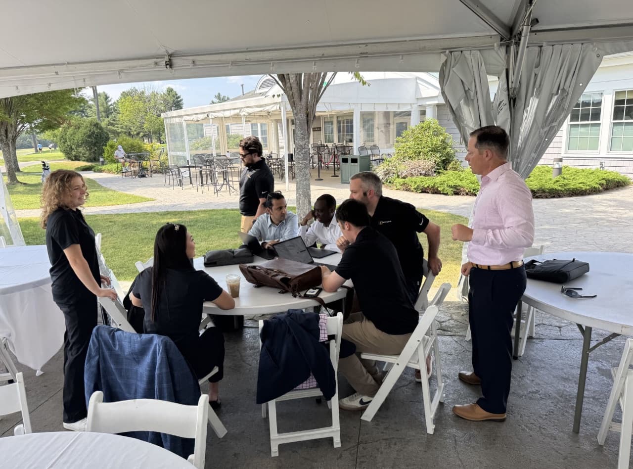 Working session around an outdoor table at a partner event